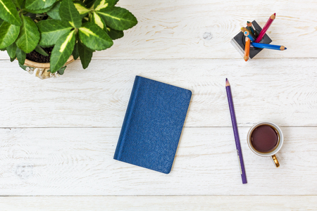 cup coffee and notepad on white boards, top viewの写真素材