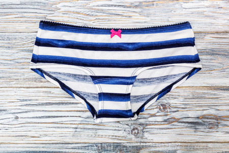 striped panties lying on the aged boardsの写真素材