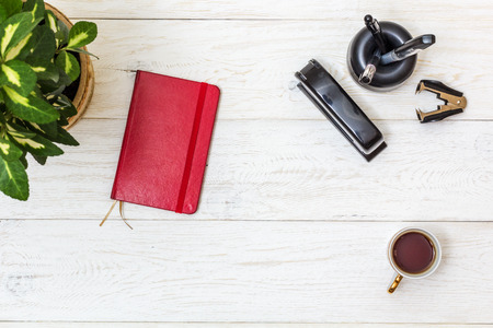 cup coffee and notepad on white boards, top viewの写真素材