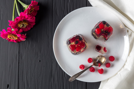 Berry jelly on plate and flowers top view. Copyspaceの写真素材