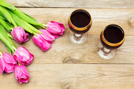two glasses of red wine and tulips, flat layの写真素材