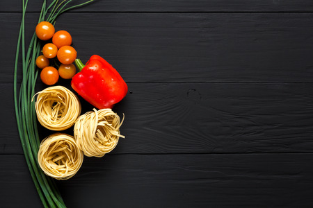 pasta and vegetables on black background, copyspaceの写真素材