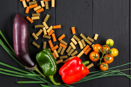 pasta and vegetables on black background, flat layの写真素材