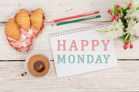 Breakfast and an inscription in a notepad: Happy monday. Top viweの写真素材