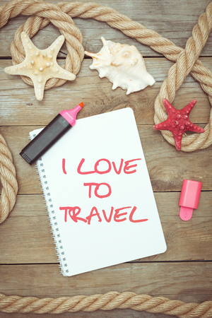 Marine objects and text in Notepad: I love to travel. Vintage color tone. Top viewの写真素材