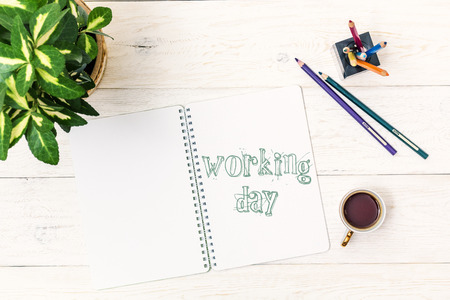 Cup of tea in morning. Text in Notepad: Working day. Top view
