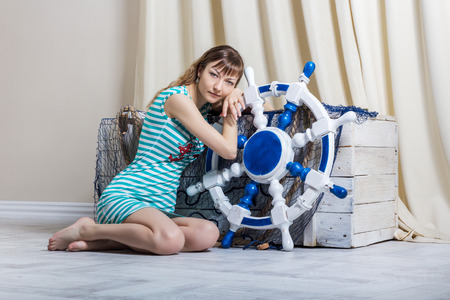 young girl with steering wheel looking at cameraの写真素材