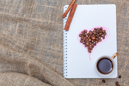 Morning coffee with cinnamon and sketchpad. Top viewの写真素材