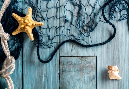 Starfish, seashell and marine network on blue boards. Copyspaceの写真素材