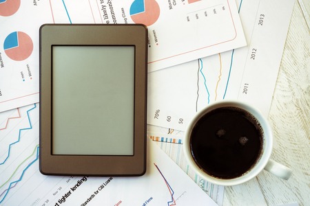 Workplace in office, coffee and ebook top viewの写真素材