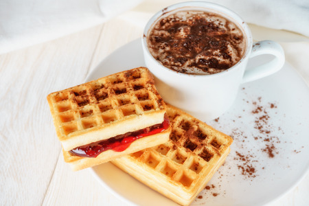 waffles with jam and cup cacao, close upの写真素材