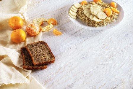 oatmeal with tangerine and banana for breakfastの写真素材