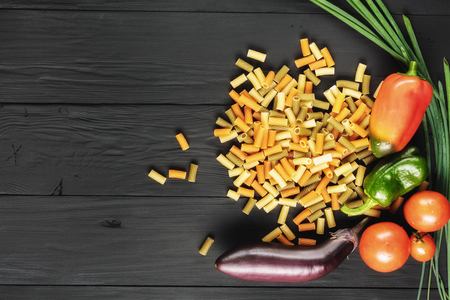 pasta and vegetables on black background, copyspaceの写真素材