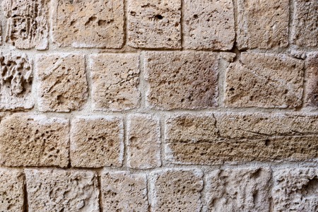texture of wall from an old badly worked stone closeupの写真素材