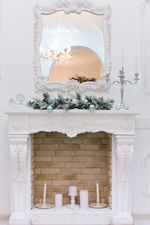 Blue Christmas balls on the fireplace in the interiorの写真素材