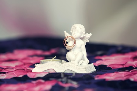 figure of an angel holding a wedding ringの写真素材