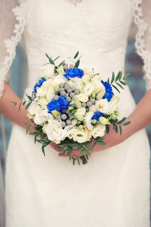 blue  bridal bouquet whith cotton in her handsの写真素材