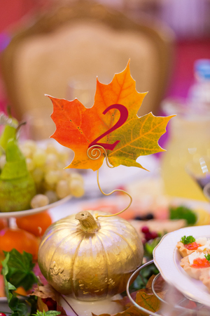 wedding decor in the form of gold pumpkin and a maple leafの写真素材