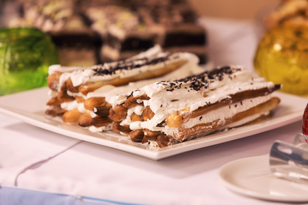 eclairs on a table with cream and cinnamonの写真素材