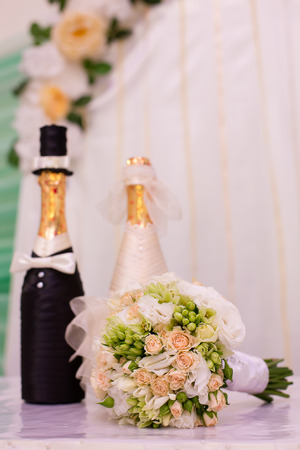 bridal bouquet on a table and wedding champagneの写真素材