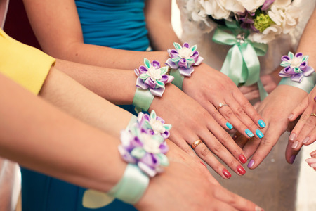 bride and bridesmaids with violet bracelets on handsの写真素材