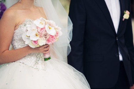 the groom holds the bride by a hand at a weddingの写真素材