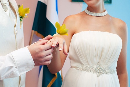 the groom dresses not weight a ring on a finger on wedding registrationの写真素材