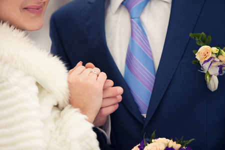 the groom and the bride hold each other by handsの写真素材