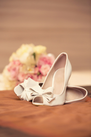 white wedding shoes of the bride and bouquetの写真素材