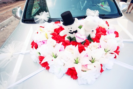 red and white decoration of the wedding car bearsの写真素材