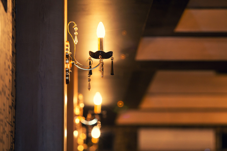 beautiful gold-plated lamp on a wallの写真素材