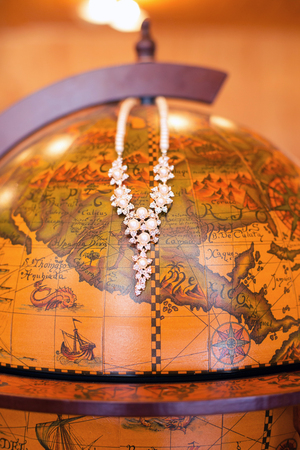 female jewelry and wooden globeの写真素材