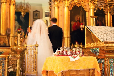 Groom and bride in church an altar on wedding ceremonyの写真素材