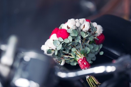 bridal bouquet from red roses and cotton on the motorcycleの写真素材