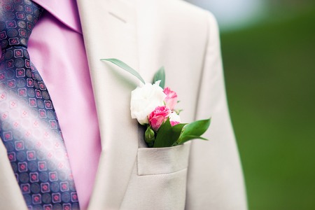 the groom's buttonhole from a rose outdoorsの写真素材