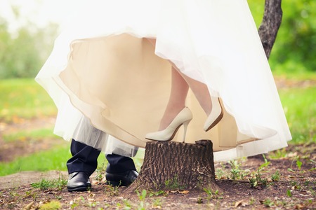 feet of the groom and the bride in the woodの写真素材