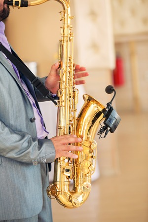 Men playing saxophone. Close up of men playing saxophoneの写真素材