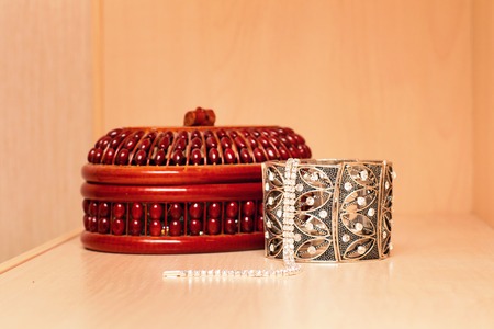 Handmade women's jewelry box with necklaces and metal bracelets