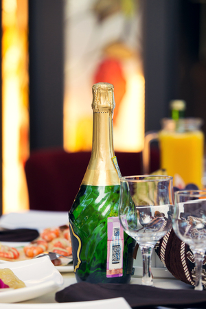 A bottle of champagne. Beautiful glasses. restaurantの写真素材