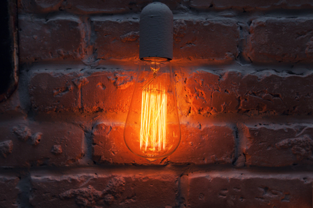 Incandescent lamps on a brick wall background.の写真素材