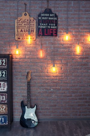 Electric guitar on a brick wall background. Grunge styleの写真素材