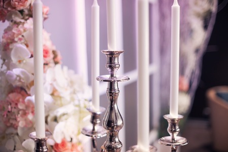 beautiful silver candelabrum in a wedding decor with flowersの写真素材