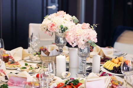 Table setting at a luxury wedding reception. Beautiful flowers on the table.の写真素材