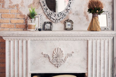fireplace in classical style and a mirror in an interiorの写真素材