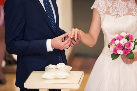 the groom dresses a ring to the bride. Weddingの写真素材