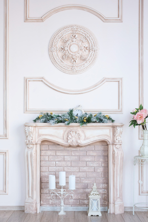 white fireplace in light room with Christmas decorationの写真素材