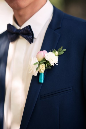 stylish buttonhole of the groom from peonies and a rose