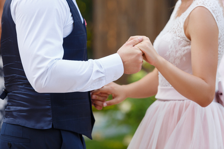 groom holds the bride by a hand. Hands newlywed close upの写真素材