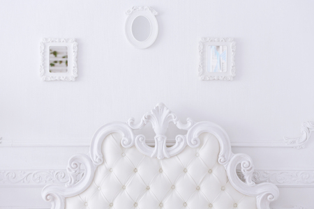Detail of a white bed in a light bedroomの写真素材