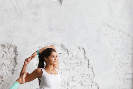Portrait of attractive woman holding green yoga or fitness mat after working out at home or in club. Friendly smiling sport instructor looking at camera. Healthy life conceptの写真素材